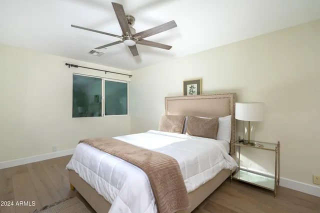 a bedroom with a bed and large window