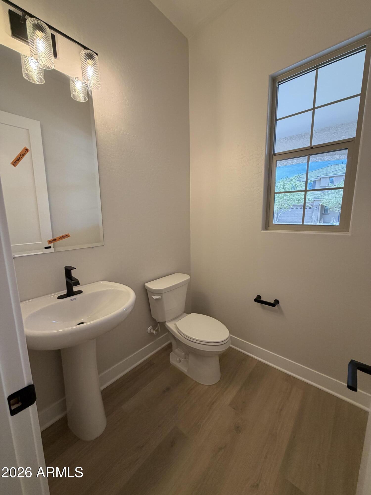 15767 West Sand Hills Road Surprise, AZ 85387 - Photo 27 of 60 a white toilet sitting next to a bathroom sink