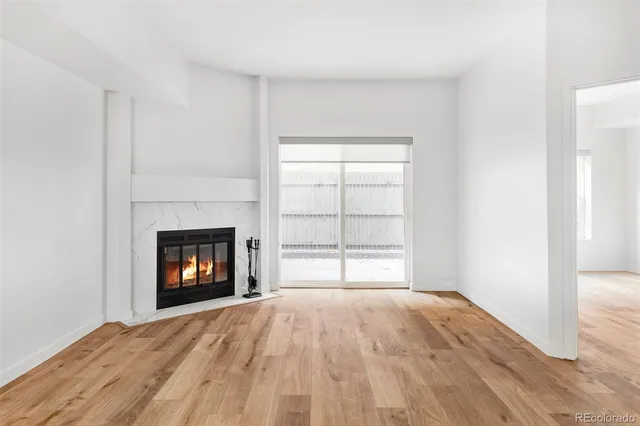 a view of empty room with a fireplace