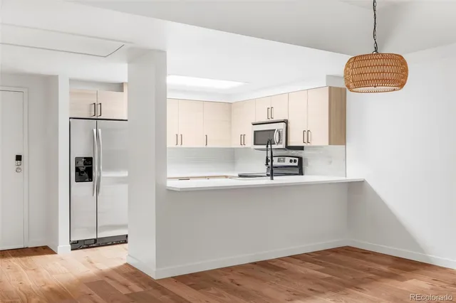 a kitchen with stainless steel appliances granite countertop a refrigerator and a sink