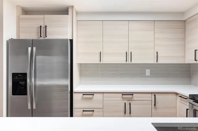 a kitchen with a refrigerator and two sink
