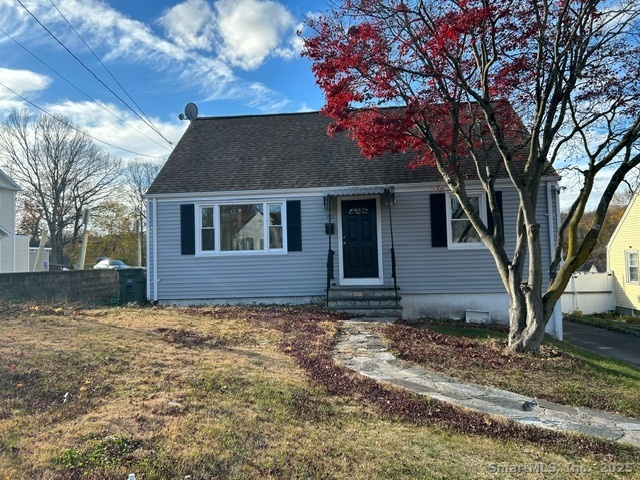 a house that has a tree in front of the house