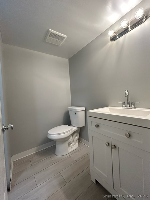 755 Old Town Road Bridgeport, CT 06606 - Photo 16 of 17 a bathroom with a toilet sink and mirror