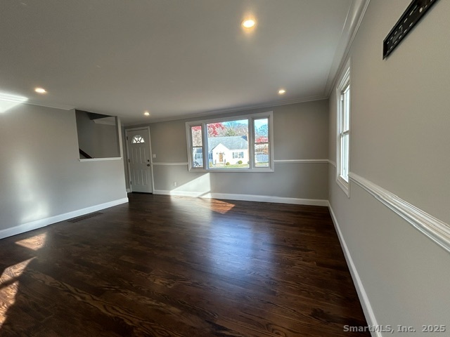 755 Old Town Road Bridgeport, CT 06606 - Photo 3 of 17 an empty room with wooden floor and windows