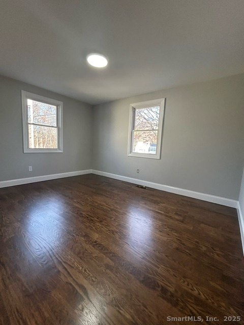 755 Old Town Road Bridgeport, CT 06606 - Photo 6 of 17 an empty room with wooden floor and windows