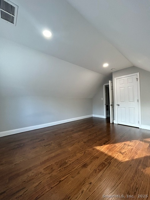 755 Old Town Road Bridgeport, CT 06606 - Photo 9 of 17 an empty room with wooden floor and windows