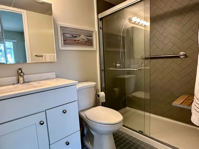 a bathroom with a sink toilet and shower