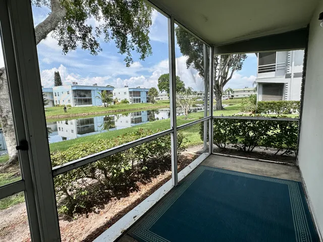 a view of a patio with table and chairs and potted plants
