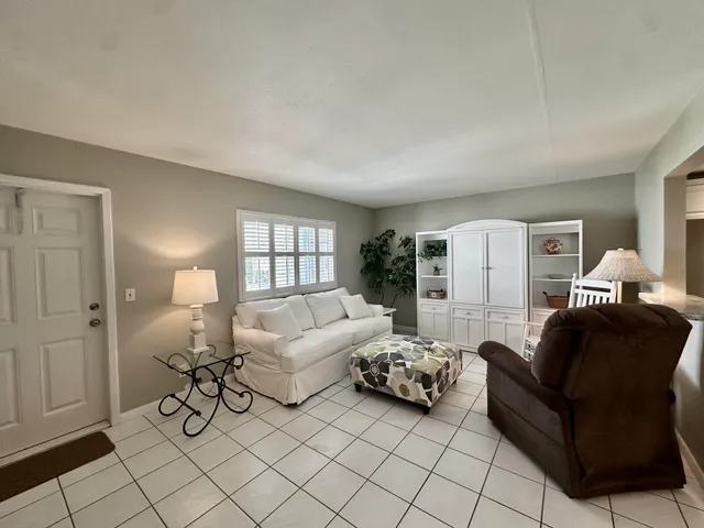a living room with furniture and a lamp