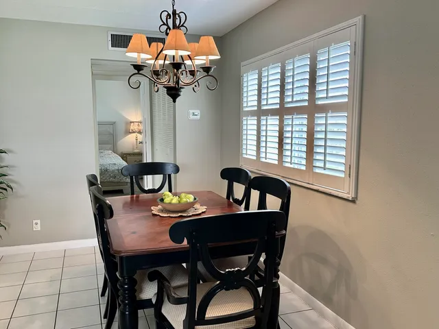 a dining room with furniture and chandelier