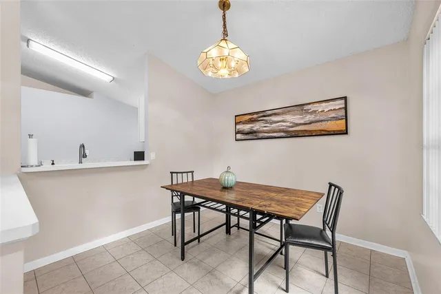 a view of a dining room with furniture and chandelier