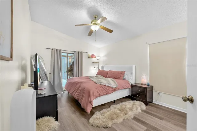 a bedroom with a bed and a large mirror