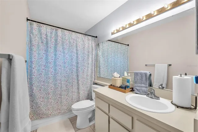 a bathroom with a sink vanity mirror and toilet