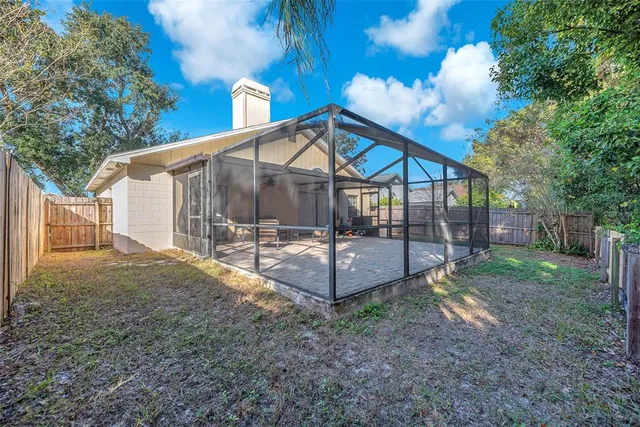 a view of a house with backyard and a garden