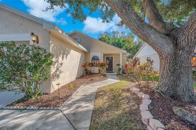 a view of a house with backyard and sitting area