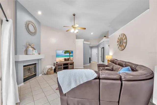 a living room with furniture a fireplace and a flat screen tv