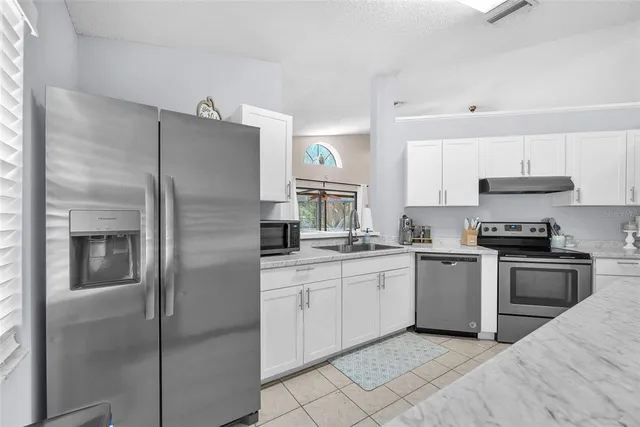 a kitchen with a sink stove and refrigerator