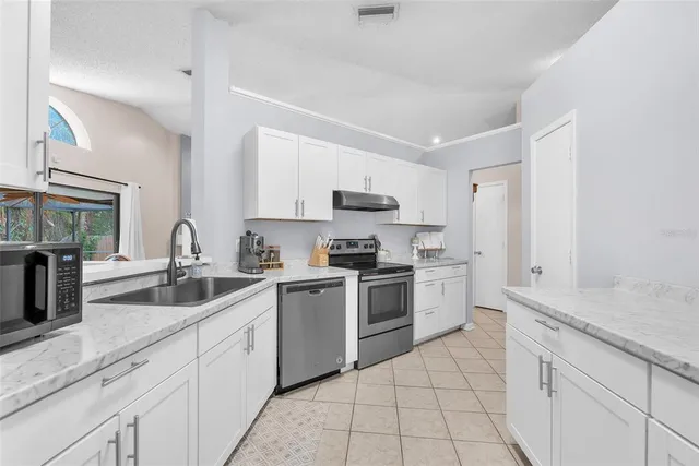 a kitchen with a sink stove and cabinets