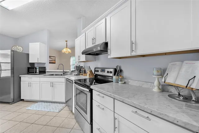 a kitchen with appliances cabinets and a sink