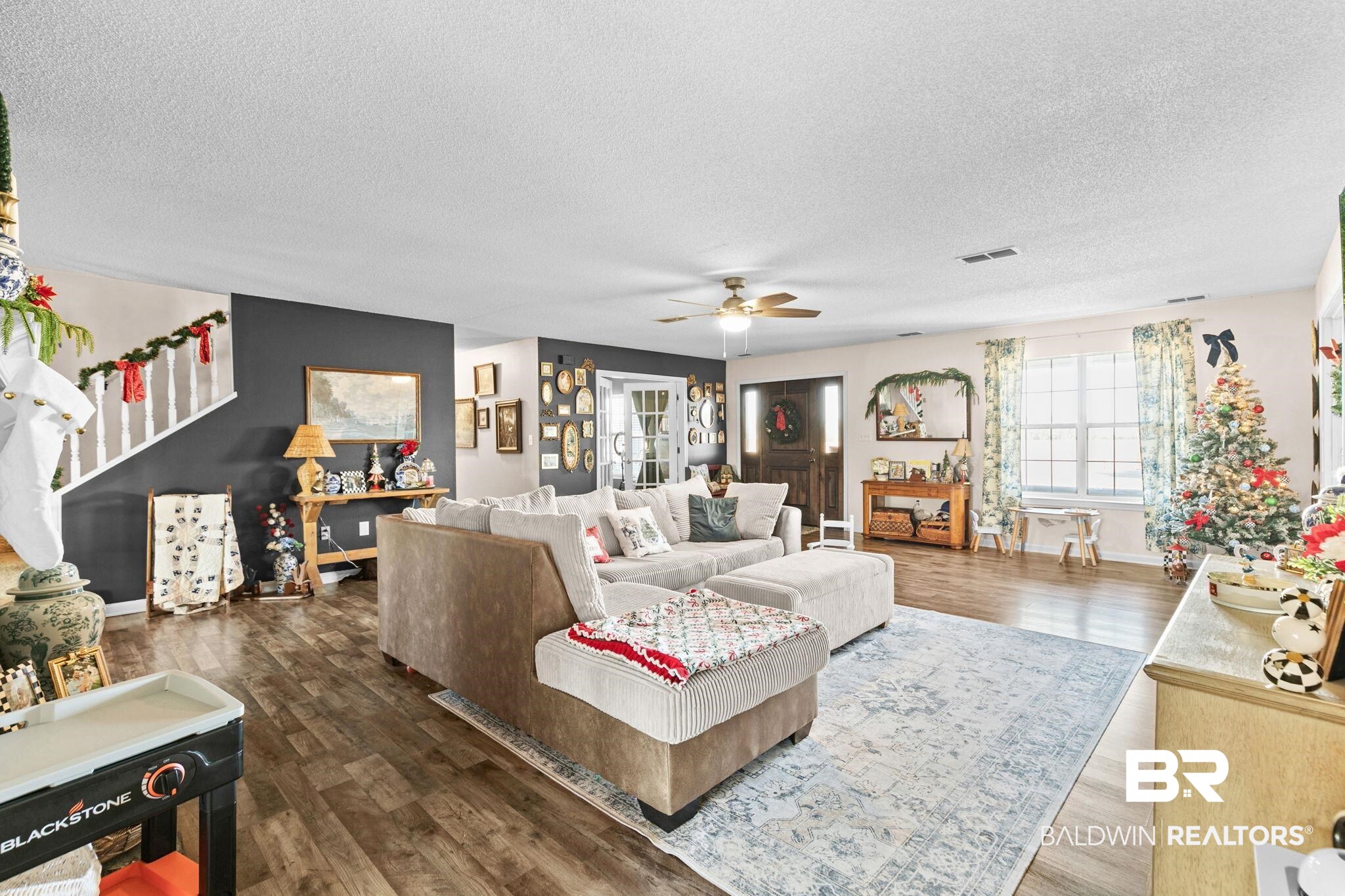3842 Experiment Farm Road Monroeville, AL 36460 - Photo 19 of 59 Living area with dark wood-style flooring, a textured ceiling, and a ceiling fan