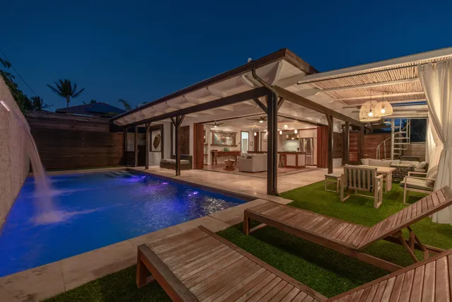 a view of a patio with table and chairs with wooden floor and fence