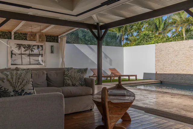 a living room with couch and a ceiling fan