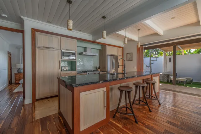 a kitchen with stainless steel appliances granite countertop a sink and cabinets