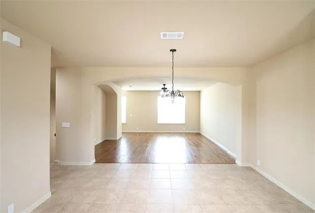 a kitchen with stainless steel appliances granite countertop a refrigerator a sink dishwasher a stove with white cabinets