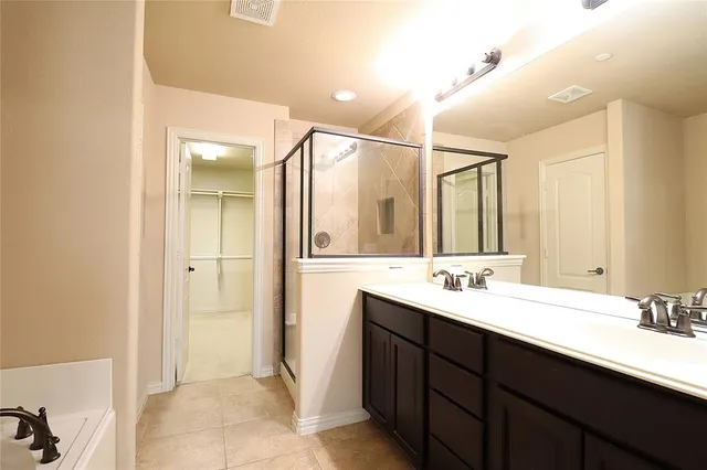 a bathroom with a bathtub sink and mirror