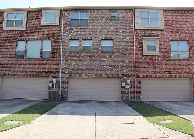 a front view of a house with a yard and a garage