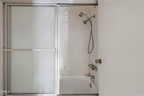 a bathroom with a glass shower door