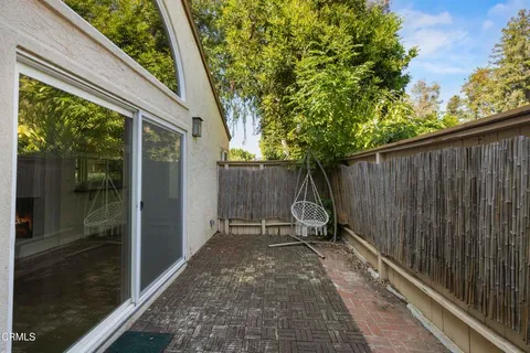 a backyard of a house with table and chairs