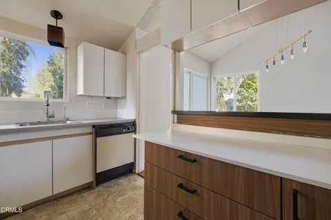 a kitchen with appliances cabinets and a sink