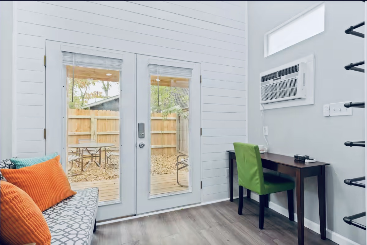 307 East 35th Street, Unit A Austin, TX 78705 - Photo 25 of 31 Floor-to-ceiling French doors open to a private outdoor space, blending indoor comfort with alfresco living.