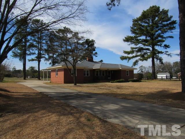 2695 Johnston County Road Angier, NC 27501 - Photo 22 of 25 a front view of a house with a yard and garage
