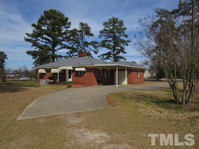 2695 Johnston County Road Angier, NC 27501 - Photo 23 of 25 a front view of a house with a yard and garage