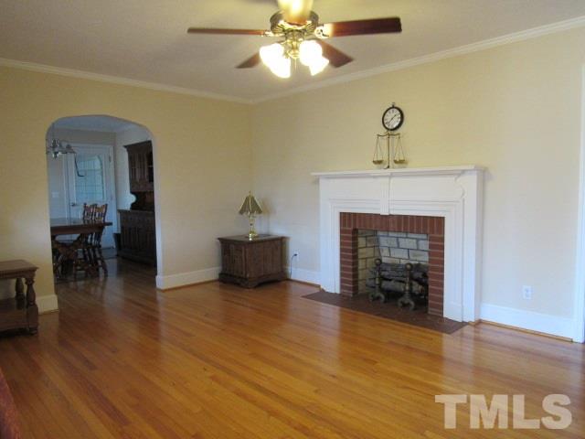 2695 Johnston County Road Angier, NC 27501 - Photo 5 of 25 a view of an empty room with wooden floor and a fireplace