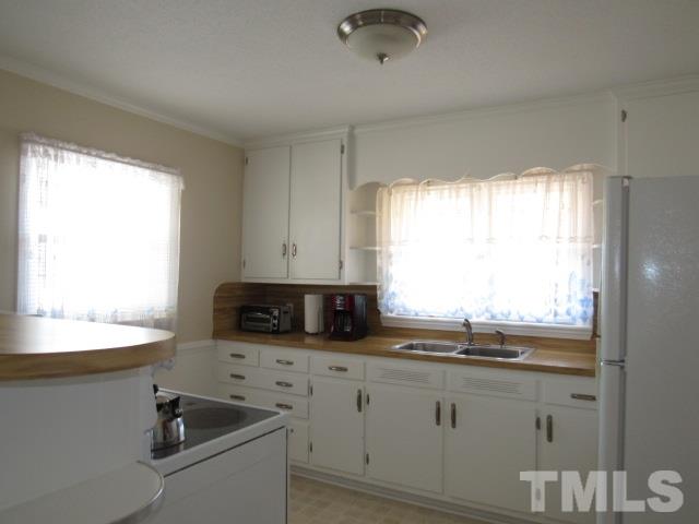 2695 Johnston County Road Angier, NC 27501 - Photo 10 of 25 a kitchen with stainless steel appliances a sink a stove and a window