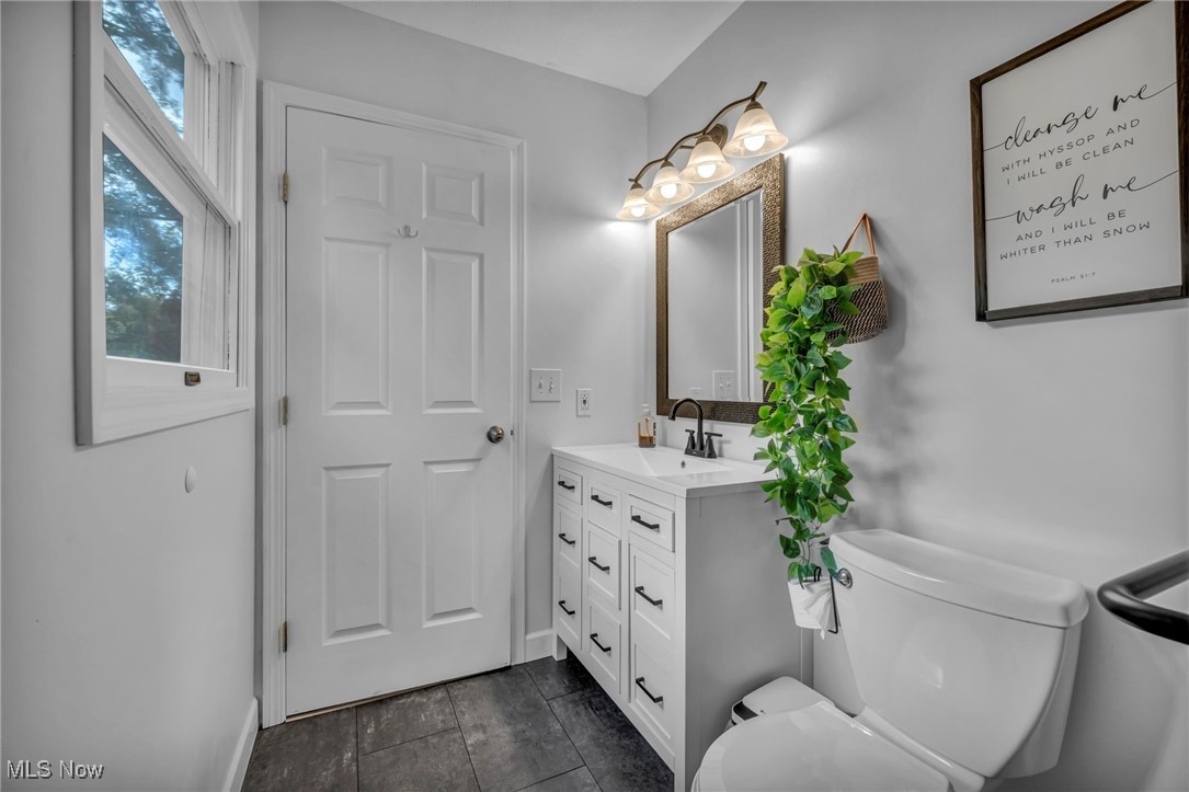 18945 Thorpe Road Chagrin Falls, OH 44023 - Photo 16 of 35 Bathroom featuring vanity and dark tile patterned flooring