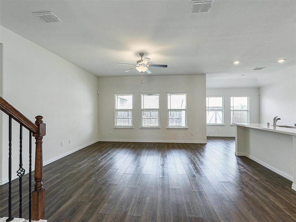 910 Torrey Avenue Princeton, TX 75407 - Photo 11 of 39 a view of an empty room with wooden floor and a window