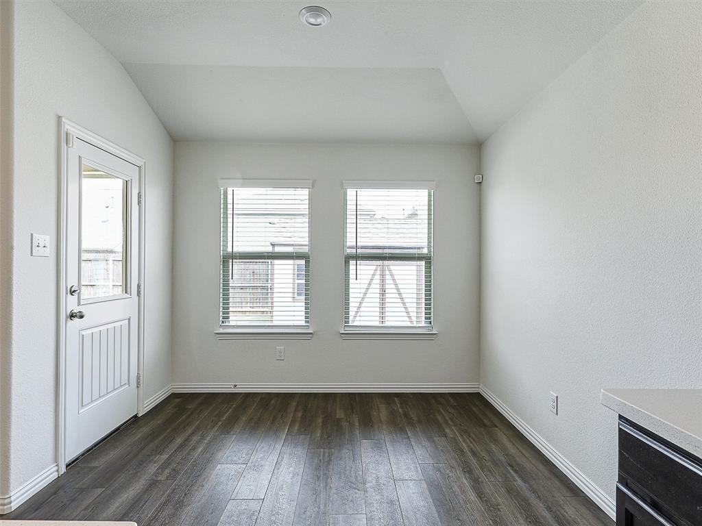 910 Torrey Avenue Princeton, TX 75407 - Photo 15 of 39 an empty room with wooden floor and windows