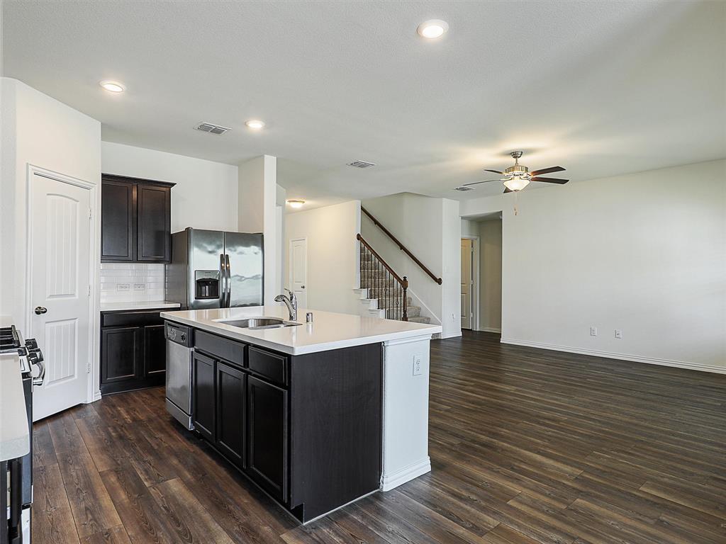 910 Torrey Avenue Princeton, TX 75407 - Photo 17 of 39 a kitchen with a sink and stove top oven