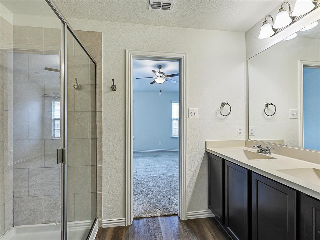 910 Torrey Avenue Princeton, TX 75407 - Photo 24 of 39 a bathroom with a sink and a mirror