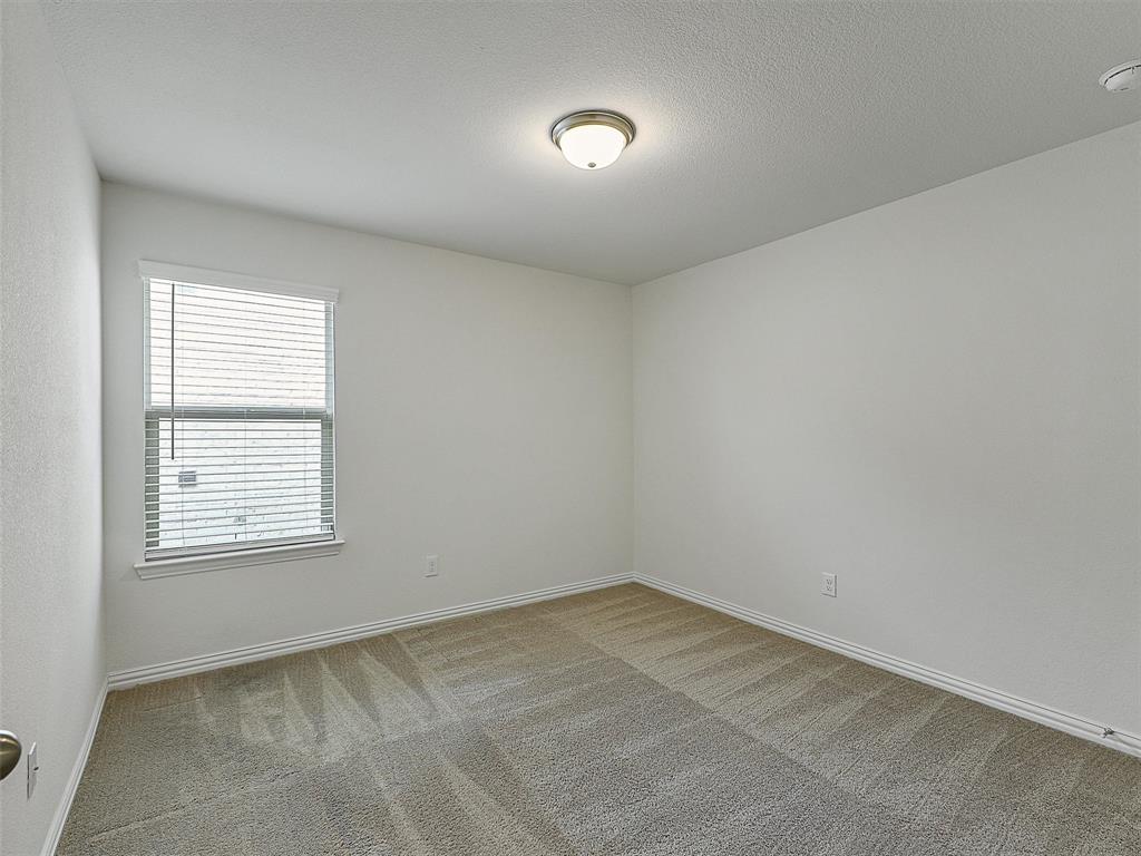 910 Torrey Avenue Princeton, TX 75407 - Photo 25 of 39 an empty room with a window