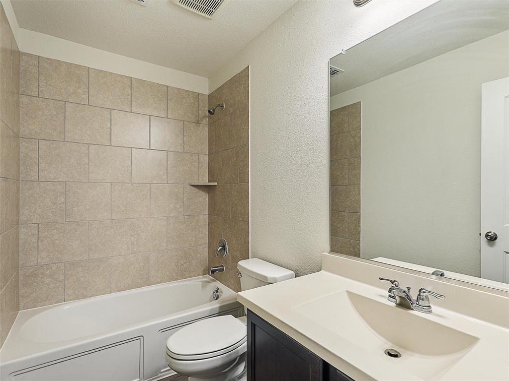 910 Torrey Avenue Princeton, TX 75407 - Photo 29 of 39 a bathroom with a sink a toilet and shower