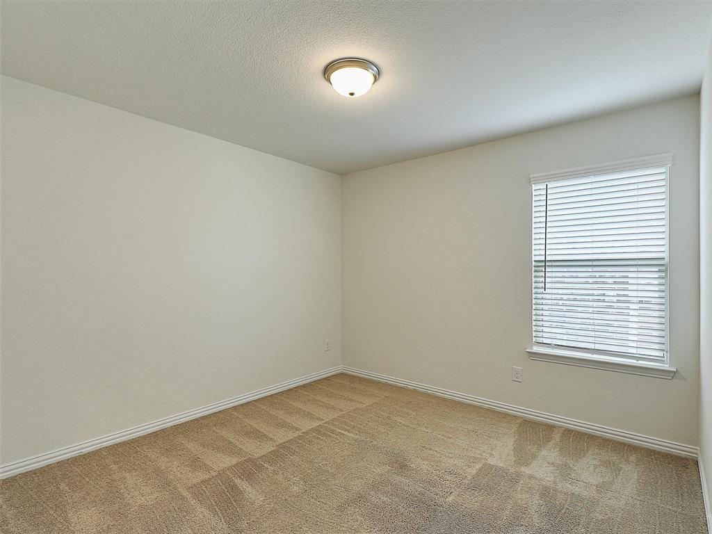 910 Torrey Avenue Princeton, TX 75407 - Photo 30 of 39 an empty room with a window