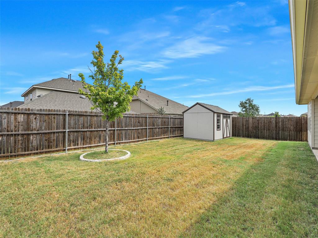 910 Torrey Avenue Princeton, TX 75407 - Photo 35 of 39 a view of a backyard with a small pool