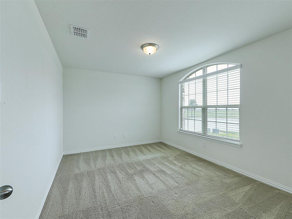 910 Torrey Avenue Princeton, TX 75407 - Photo 4 of 39 an empty room with a window