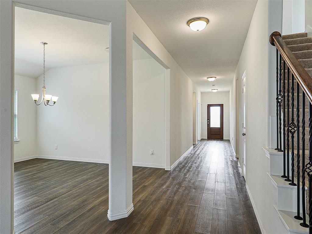 910 Torrey Avenue Princeton, TX 75407 - Photo 6 of 39 a view of a hallway with wooden floor
