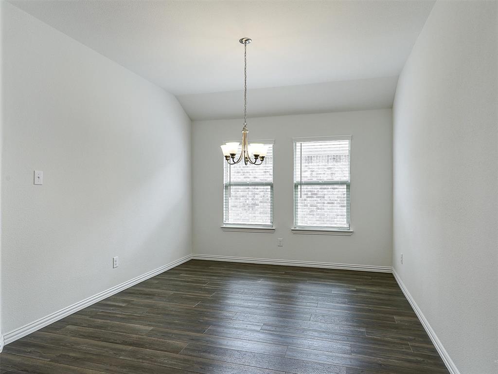 910 Torrey Avenue Princeton, TX 75407 - Photo 7 of 39 an empty room with wooden floor and window